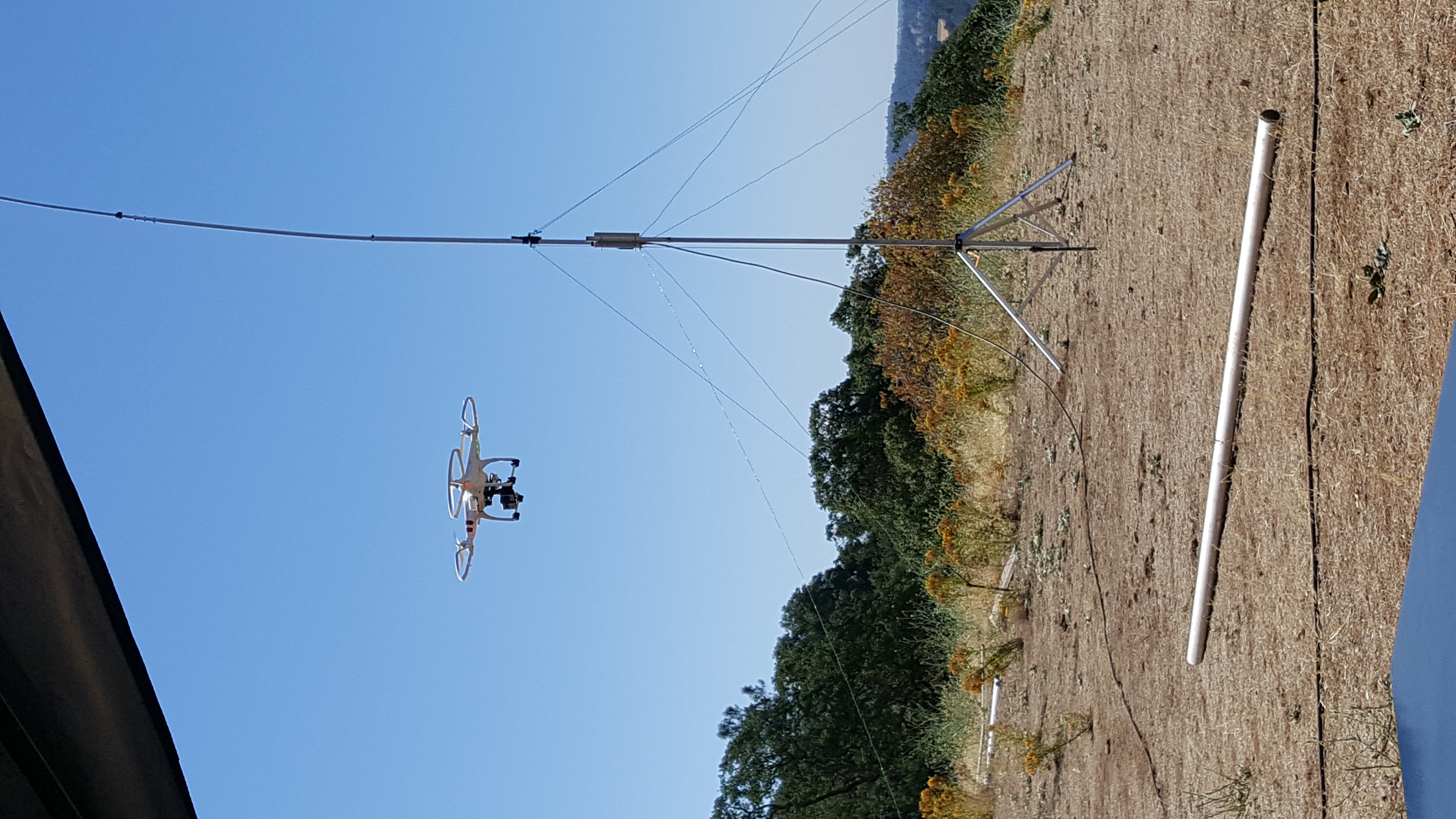 A drone inspects the vertical antenna