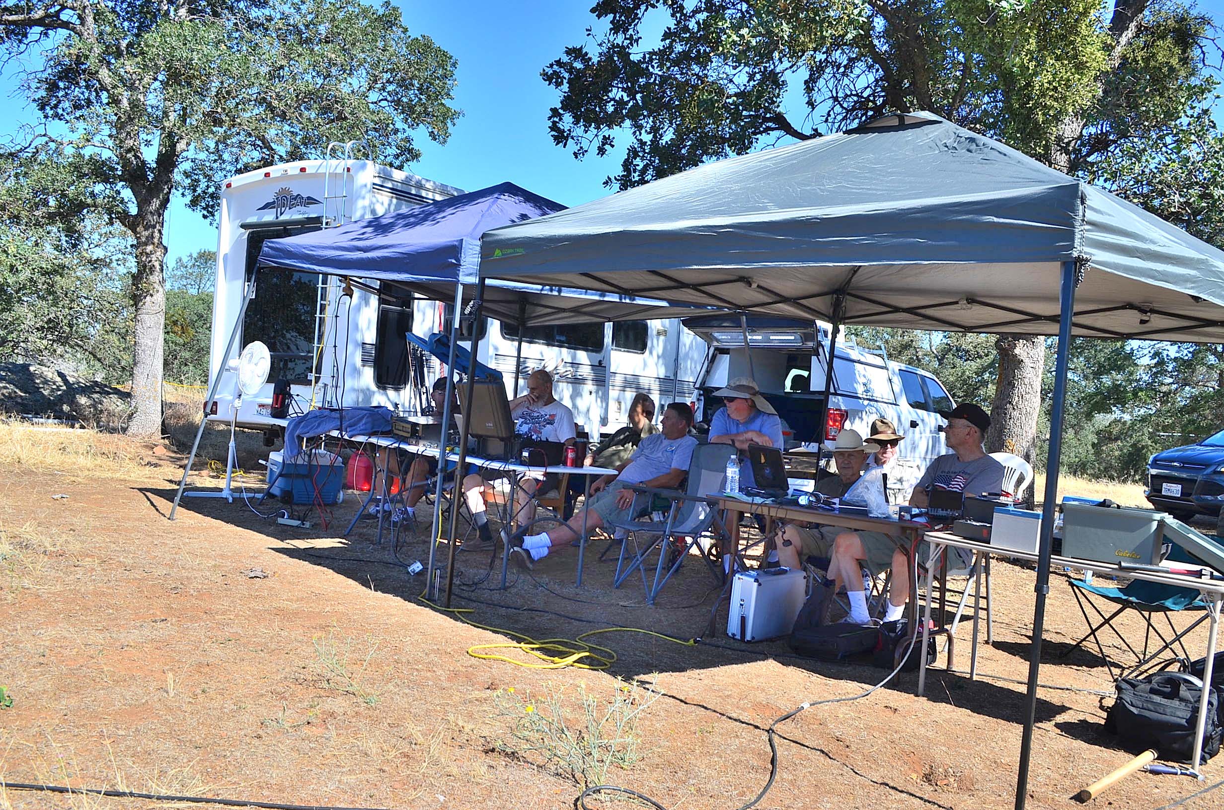 The Field Day crew works contacts in the afternoon heat