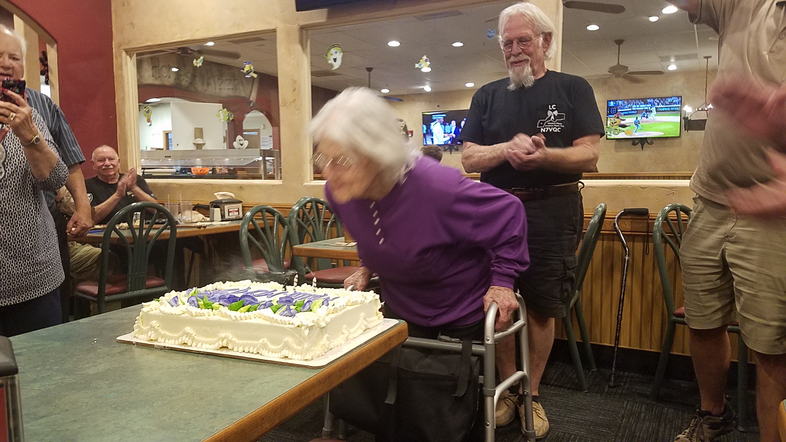 Birthday Mom blows out candles on her cake