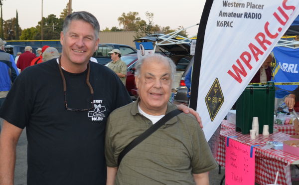 Jerry JKH stands with a raffle prize winner