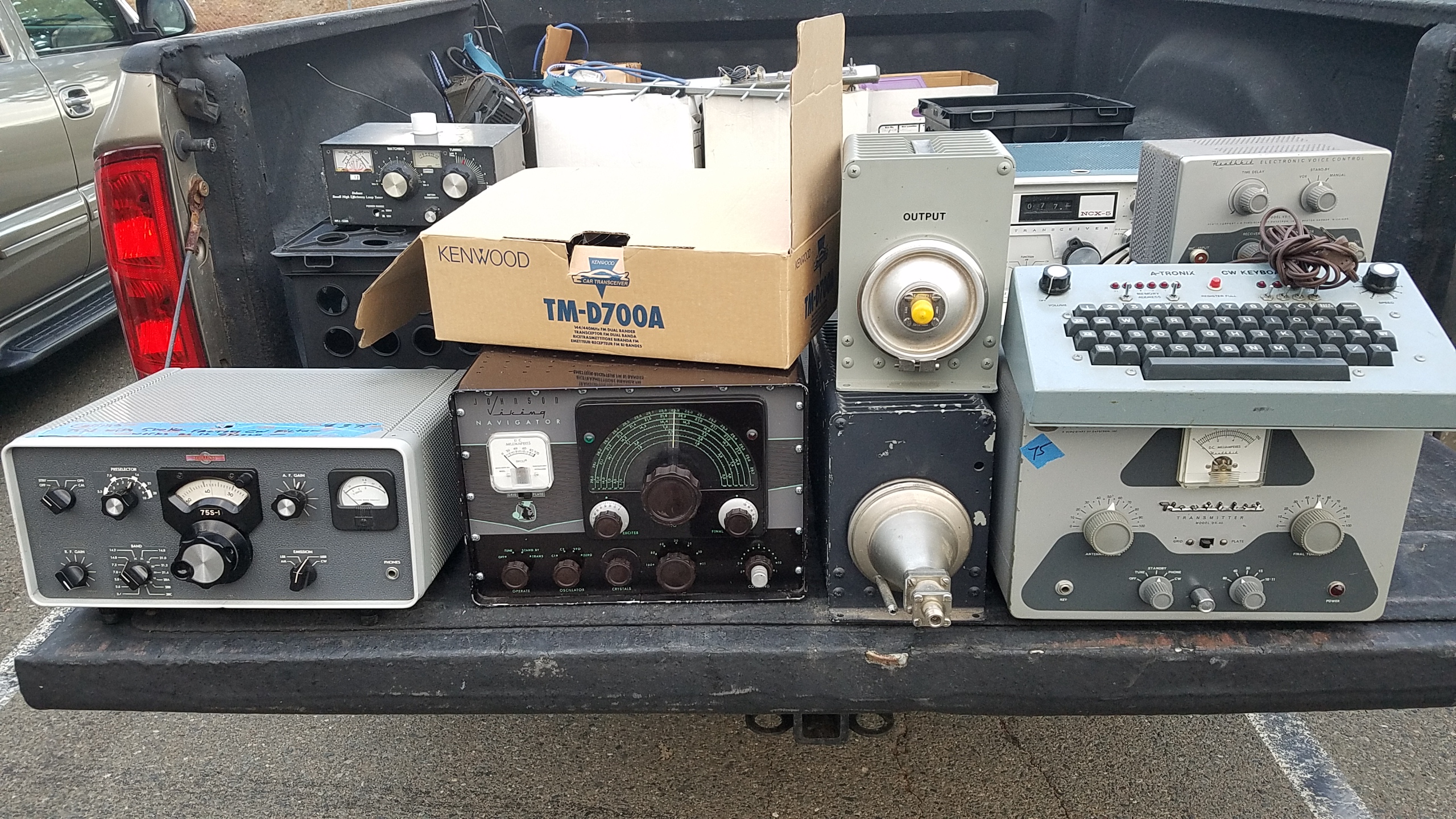 A table stacked with ham radio treasures
