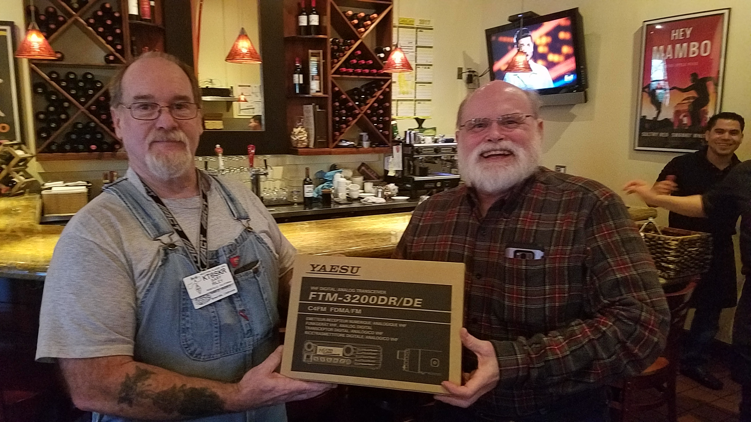Michael BUK awards a mobile transceiver raffle prize to Gary SKR
