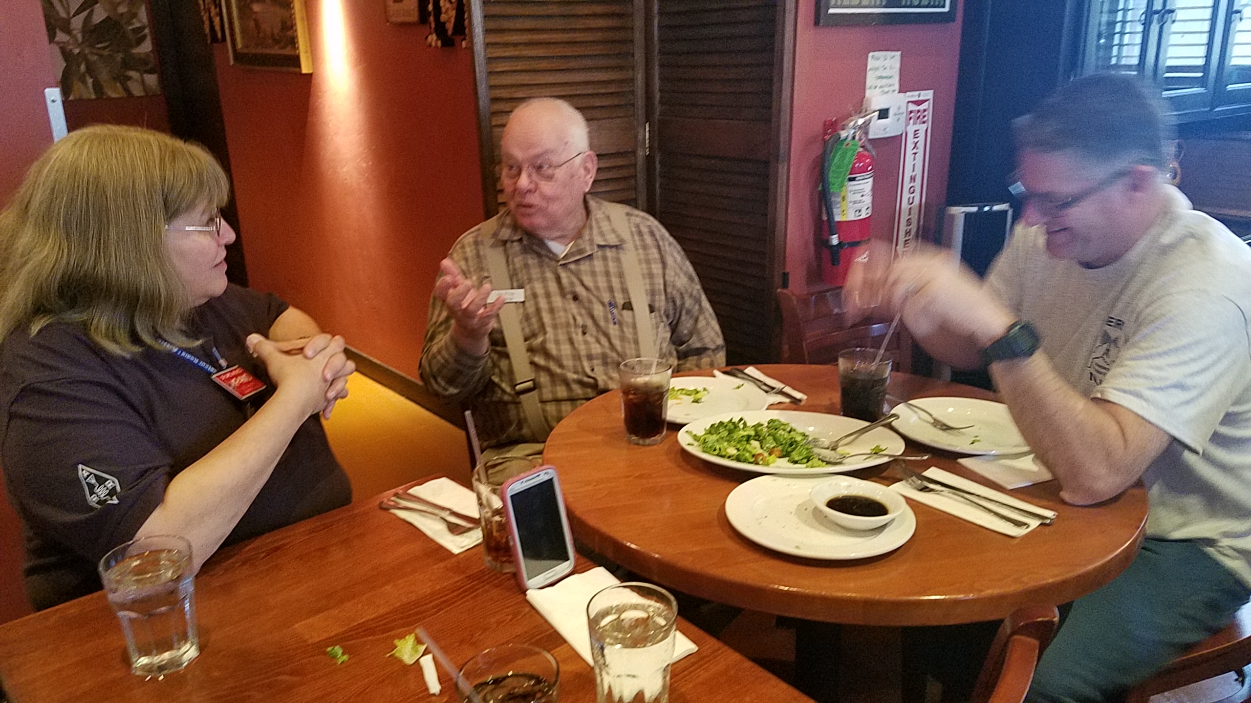 ARRL SM Carol KP4MD converses with a guest and Jerry JKH